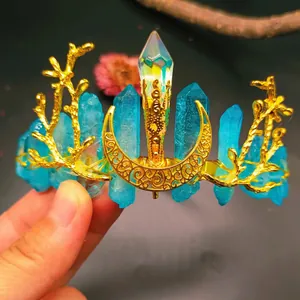 Detail of handmade gold coral branch tiara with blue crystals and moon moonstone pillar