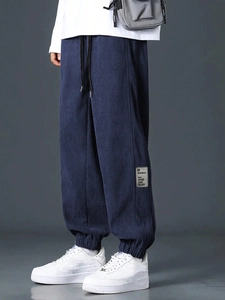 Men's dark blue corduroy cargo pants featuring elastic waist and drawstring design