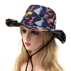 Detailed view of sun hat with pink waves and blue grid patterns and adjustable cord