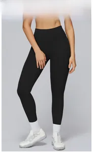 Detail of high-waist yoga leggings in premium black with wide tummy-control waistband