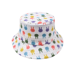 Detail of kids white bucket hat featuring colorful cartoon rabbit patterns for sun protection