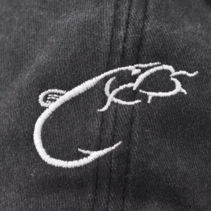 Vintage washed baseball cap featuring white fish hook embroidery on black cotton fabric