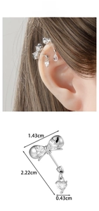 Detail view showing dimensions of silver bow and heart pendant ear cuff with zircons