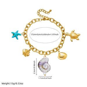 Detail of gold chain bracelet featuring ocean charms like starfish, sea turtle and pearls