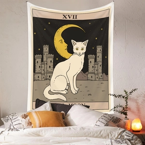 Detail of tarot cat tapestry featuring white cat and moon motif in a cozy bedroom
