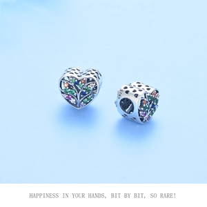 Macro detail of S925 sterling silver heart charm bead with colorful zircon and tree motif
