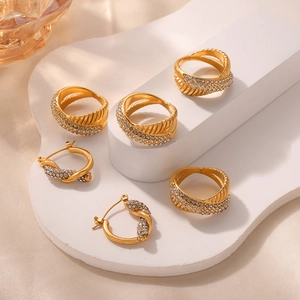 Luxe gold plated twisted jewelry set with rings and earrings featuring sparkling zircon inlay