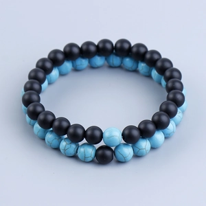 Detail view of 8mm matte black lava and blue turquoise beaded stretch bracelets