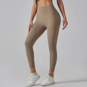 Detail of high-waisted khaki yoga pants featuring a side pocket and moisture-wicking fabric