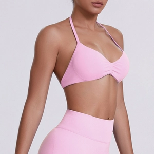 Detail of pink halter neck sports bra with ruched front and matching high waist leggings
