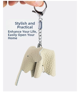Detail of light beige litchi grain leather elephant keychain with silver lobster clasp