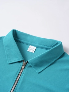 Close-up of the quarter-zip collar and waffle texture on a men's polyester polo shirt