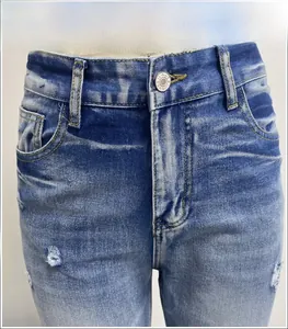 Detailed view of silver button and distressed denim texture on high-waist flared jeans