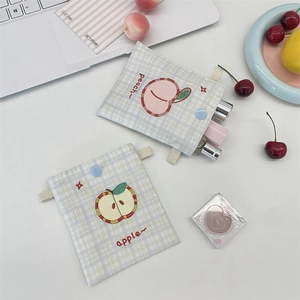 Detail of peach and apple embroidery on cute checkered fabric makeup bags with snap closure