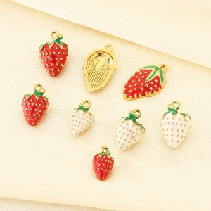 Detailed view of colorful strawberry enamel pendants with gold plating for jewelry making