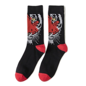 Detail of cotton crew socks with a bold tiger print and red heel and toe contrast