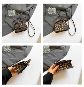 Detail view of leopard print crossbody bag with gold hardware and reinforced handle