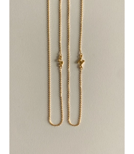 Close-up of gold-plated S925 silver necklace featuring H and S letter pendants