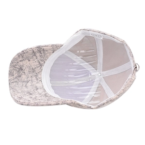 Detailed interior of mesh baseball cap showing 100% polyester label and quality stitching