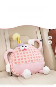 Close-up of pink lamb wool monster car headrest pillow on a beige seat with soft texture