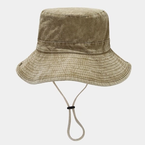 Detailed texture of washed cotton bucket hat with adjustable chin strap and drawstring