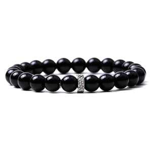 Detailed close-up of a black agate beaded bracelet featuring a silver geometric metal spacer