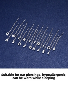 Macro detail of S999 silver alphabet threader earring featuring hypoallergenic long chain