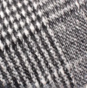 Detailed macro view of black and white houndstooth wool fabric texture for newsboy cap