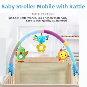 Detail of baby stroller arch with colorful owl, elephant, and sun plush hanging toys