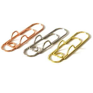 Set of heart-shaped metal pen clips in rose gold, silver, and gold finish on white background