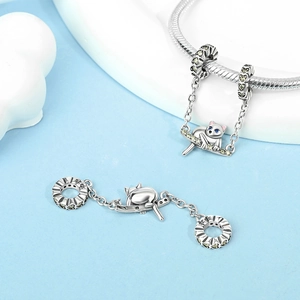Macro detail of S925 sterling silver cat on a swing charm for DIY jewelry bracelets