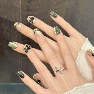 Star Butterfly black and gold press-on nails with 3D bows and emerald green glitter finish