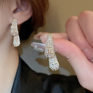 Elegant gold earrings with sparkling drop zircon stones in a sleek geometric tassel design