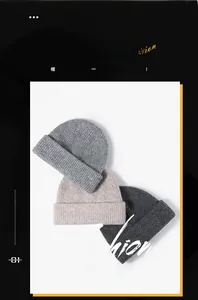 Close-up of ribbed knit beanies in grey and beige showing thick textured winter fabric
