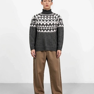 Detail of grey knitted turtleneck sweater with diamond pattern and soft knit texture