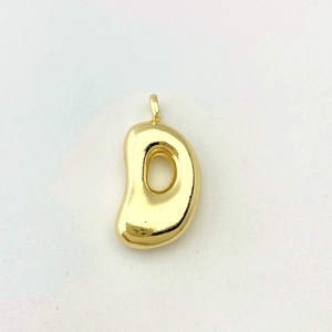 Macro detail of glossy golden balloon letter D pendant necklace with a mirror finish