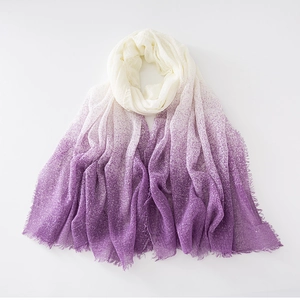 Detailed view of lightweight white to purple gradient scarf with delicate tassel edges