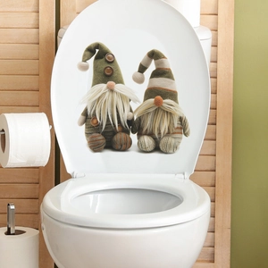 Close-up of Nordic Tomte gnome wall stickers on a white toilet lid for Christmas decor