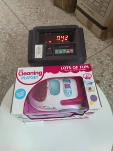 Kids cleaning playset in pink and purple colors on a digital scale showing product weight