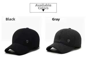 Detail view of winter baseball caps in black and grey with refined metal logo ornaments