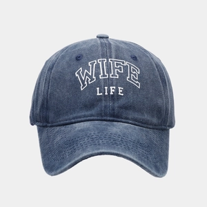 Detail of WIFE LIFE embroidery on washed navy blue denim baseball cap with white outline