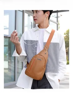 Brown PU leather chest bag with red zipper detail worn by a model in urban setting