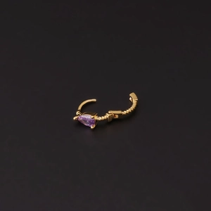 Golden spiral ear hoop featuring a purple teardrop zircon on a sleek black background