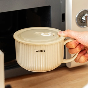 Japanese style beige ceramic noodle bowl with lid being placed in a microwave