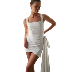Detailed view of white square neck mini dress with side ribbon draping and waist pleats