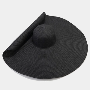 Close-up detail of high-density black straw weaving on a large brim sun protection hat