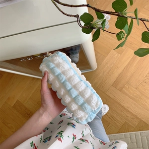 Detail of blue and white bubble fabric pencil case showing soft cloud-like texture