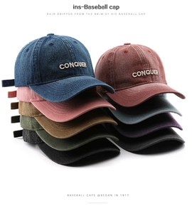 Detail shot of multi-color vintage denim baseball caps with CONQUER embroidery