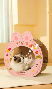 Pink bunny shaped cardboard cat scratcher bed with two cats sleeping inside