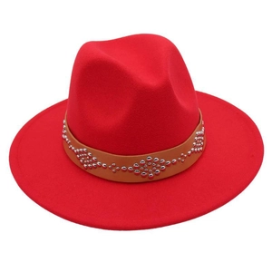 Detail of red wool felt fedora featuring a brown leather band with silver metal studs